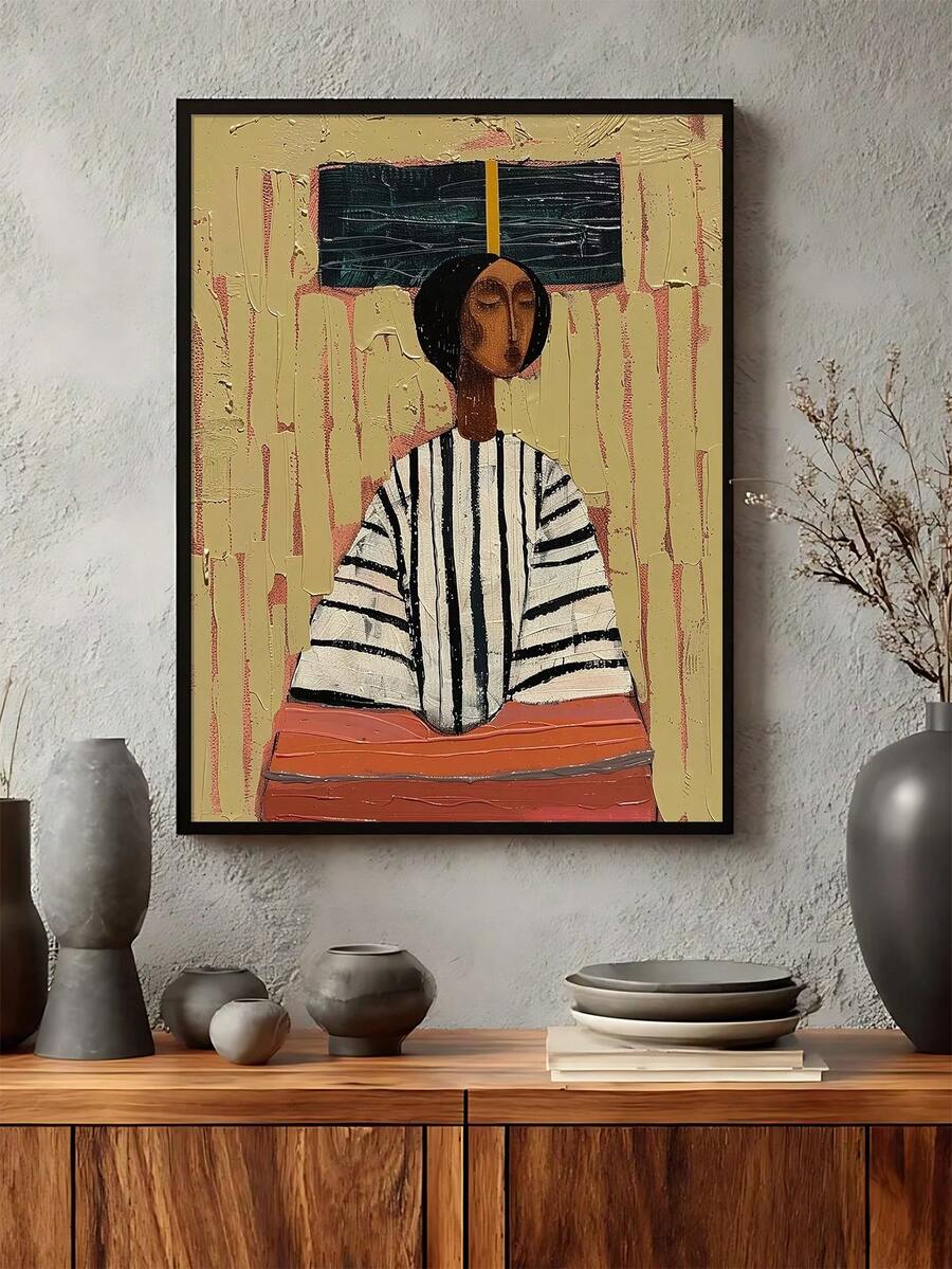 Abstract African woman canvas poster in a black frame above a wood console with ceramics