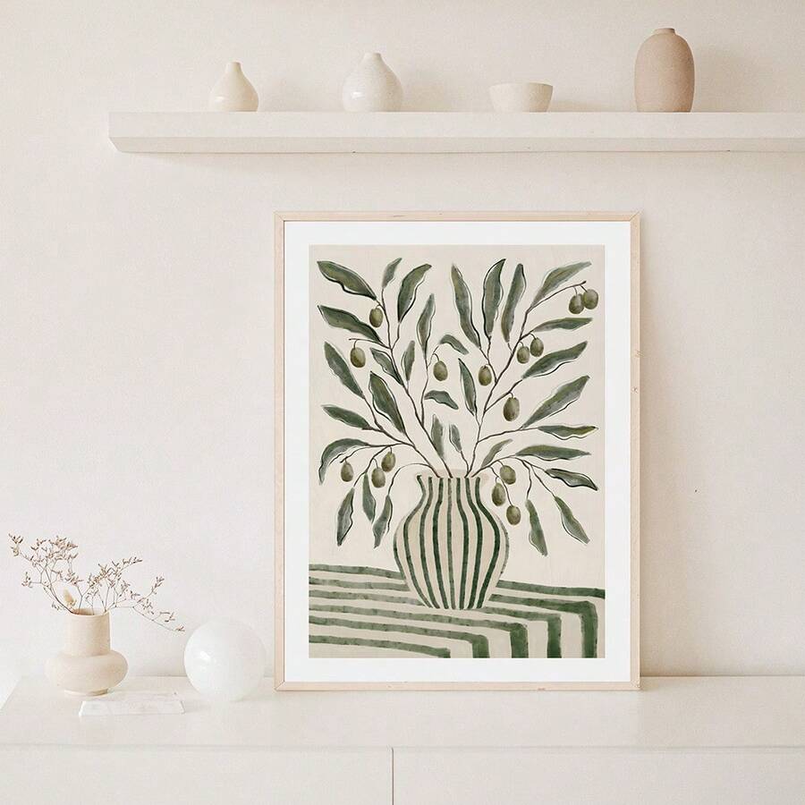 Framed green olive branch vase botanical print on white cabinet with neutral shelf decor