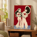 Close view of two stylized women on a red canvas poster with blue geometric border