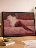 Woman in white feather top and red tights reclining on pink sofa in black-framed print