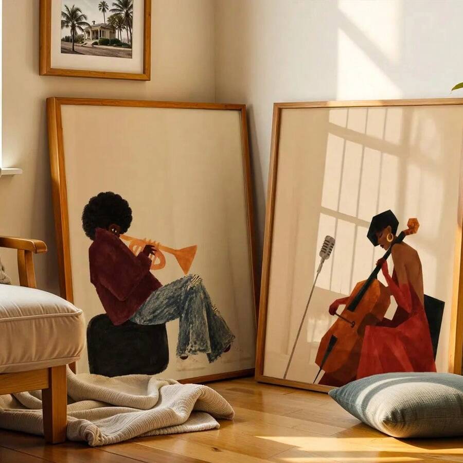 Two framed music posters leaned against a wall, showing a seated trumpet player and cellist