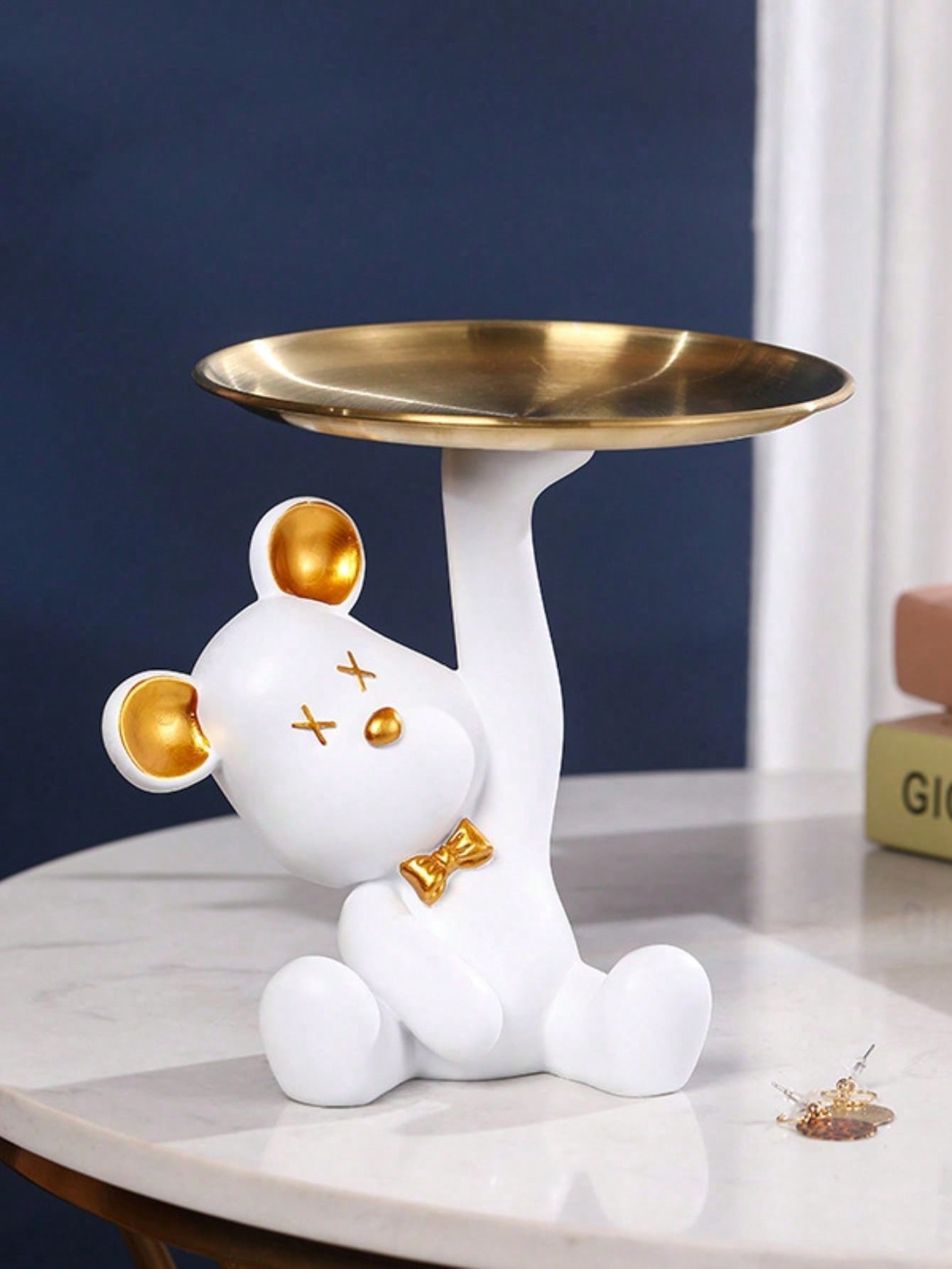 Add a playful touch to your living room with our Adorable Bear Shaped Tray. Keep your space organized while adding a cute and charming decorative piece. Crafted with high-quality materials, this tray is perfect for holding small items or serving snacks. Embrace a cute and organized living room with our adorable tray.