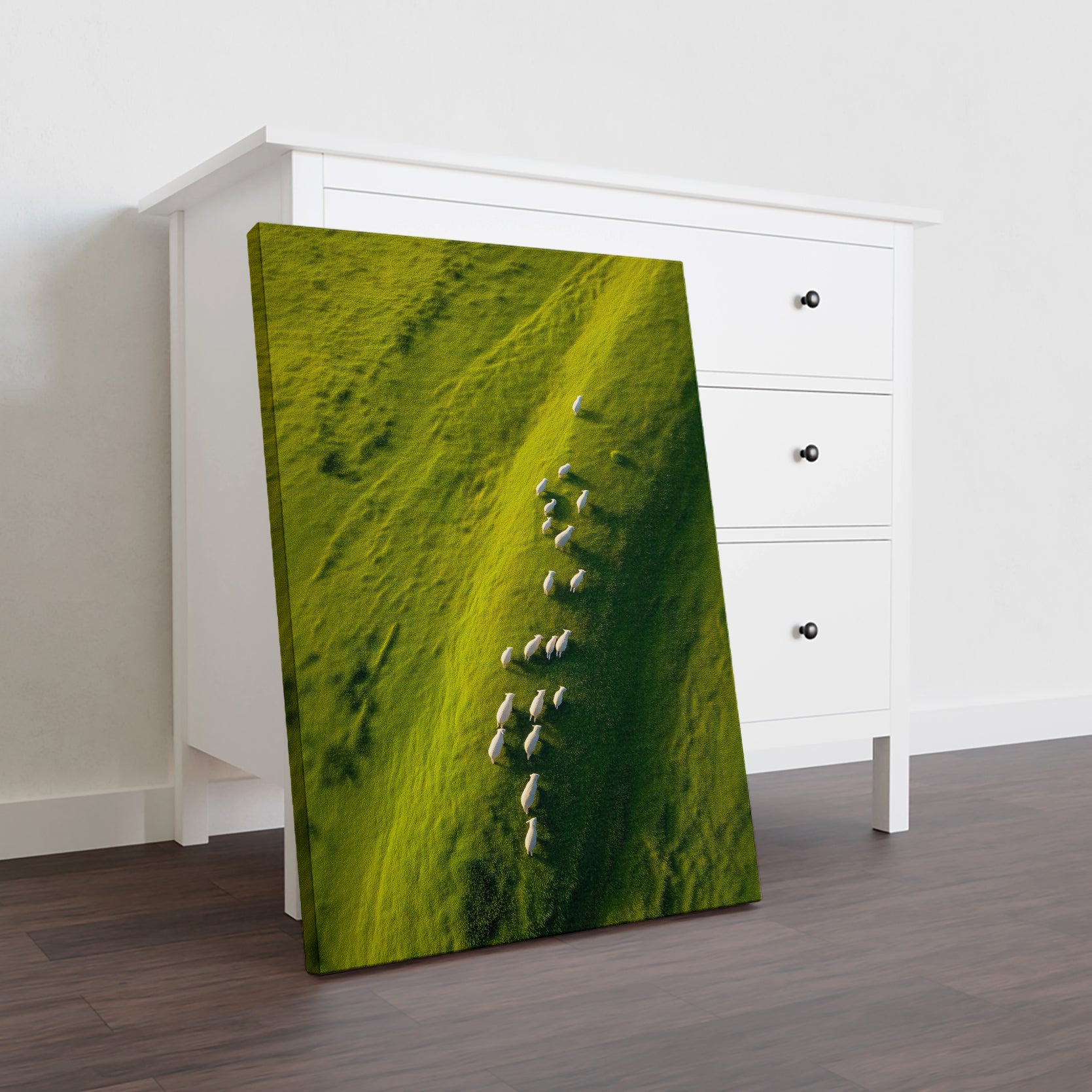 Capture the serene beauty of pastoral landscapes with this stunning aerial nature photography canvas print. Featuring a breathtaking view of rolling green hillsides dotted with white sheep bathed in natural sunlight, this piece brings tranquility and sophistication to any interior space.
