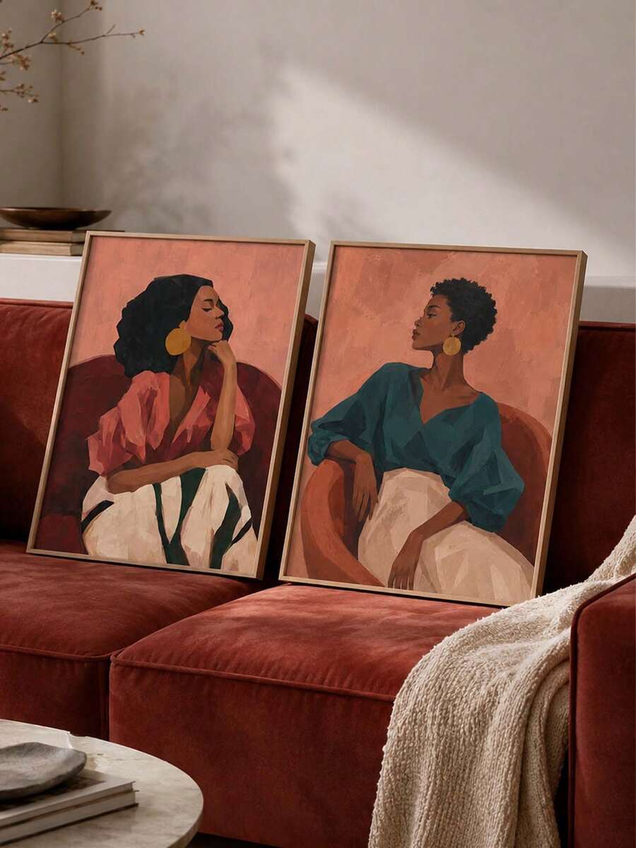 Afrocentric women portrait canvas pair above a red velvet sofa