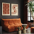 Two-piece terracotta Bauhaus wall art above rust living room sofa