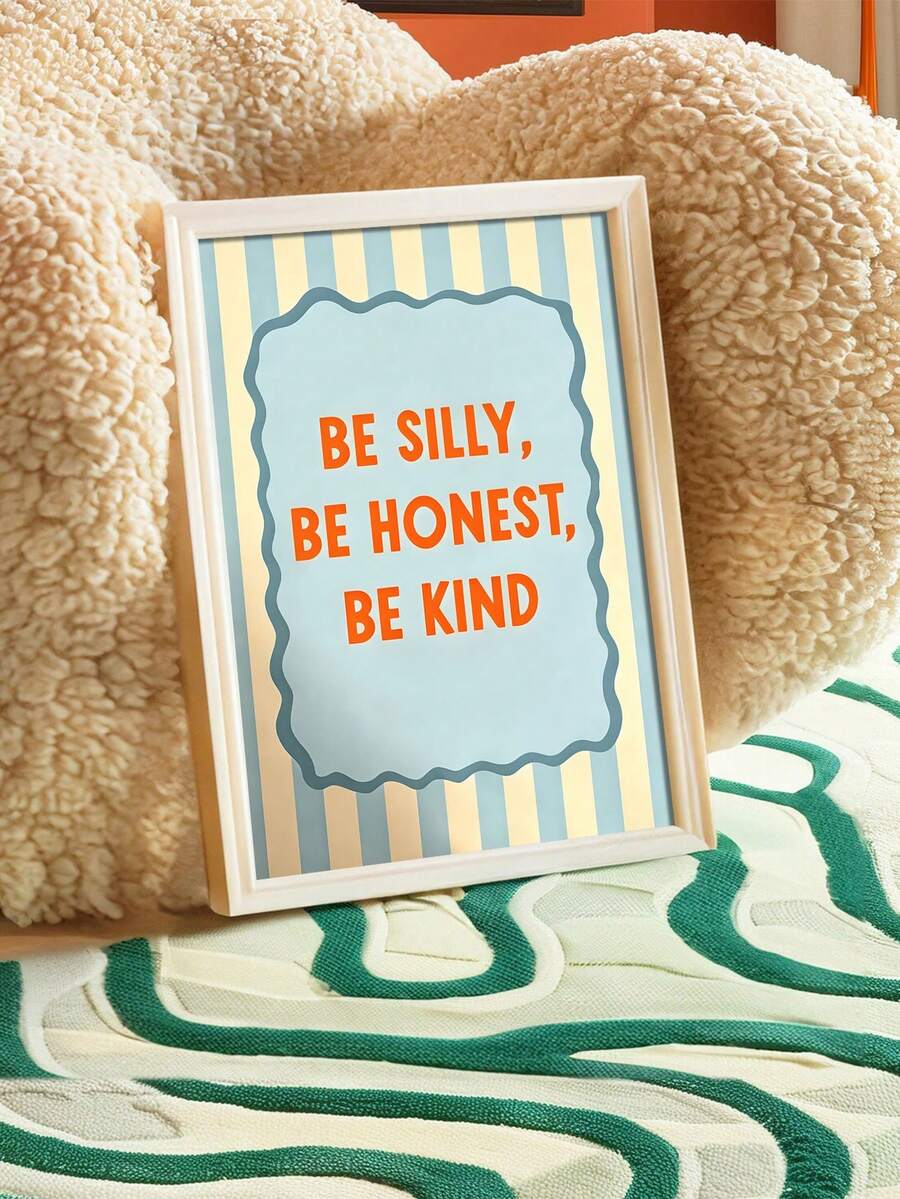 Framed Be Silly Be Honest Be Kind nursery canvas poster with blue stripes and orange typography beside a sofa