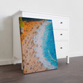 Elevate your interior with this stunning aerial perspective canvas art, capturing the serene beauty of pristine coastlines. The composition showcases crystalline turquoise waters meeting golden sandy shores, rendered with meticulous detail that draws the eye and invites contemplation. Perfect for living rooms, bedrooms, or any space requiring a sophisticated coastal accent, this piece brings the tranquility of seaside landscapes indoors.