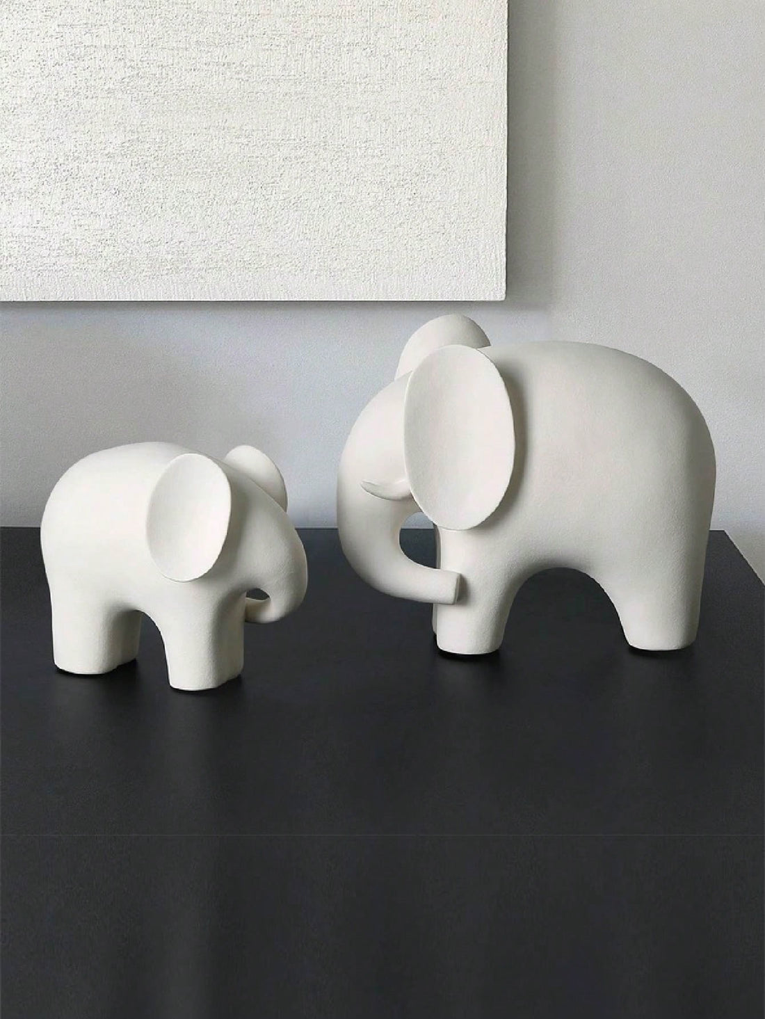 This charming elephant statue is not only aesthetically pleasing but also carries a symbolic meaning. With its trunk raised in the air, it is believed to bring good luck and prosperity to your home. This piece makes for a unique and meaningful addition to any home décor, generating positive energy and promoting harmony and balance.