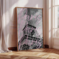 Framed black-and-white Eiffel Tower print with pink Paris script in a sunlit room