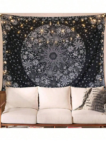 Black and white mandala tapestry displayed above sofa with string lights