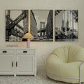 Three framed black and white New York prints above modern sideboard