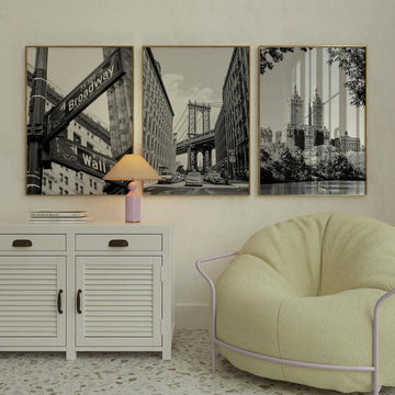 Three framed black and white New York prints above modern sideboard