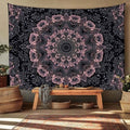 Black and pink mandala tapestry hanging above wood bench in boho living room