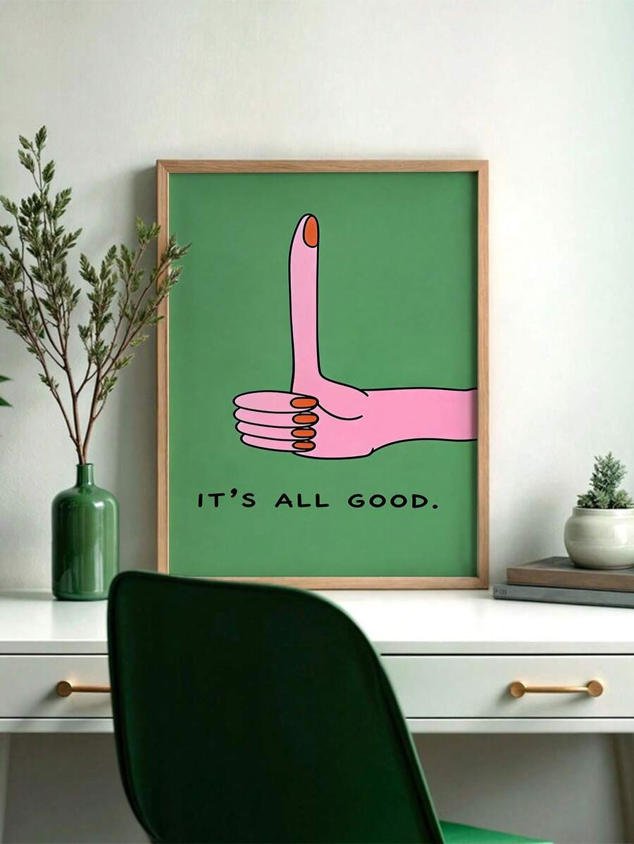 Framed pink thumbs-up print reading It's All Good above a home office desk
