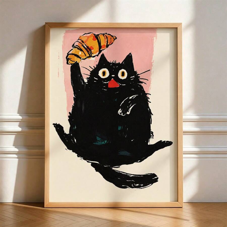 Framed black cat holding croissant canvas poster against a pink background