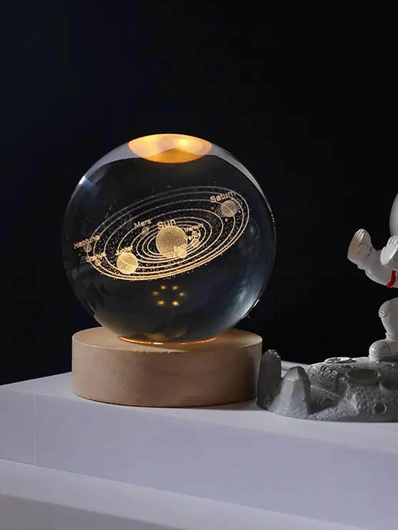Illuminate your room with the Celestial Crystal Ball Night Light. This cosmic home decor accent features a stunning crystal ball that lights up to create a peaceful and dreamy atmosphere. Perfect for any bedroom or living space, this unique piece is a must-have for any celestial enthusiast.