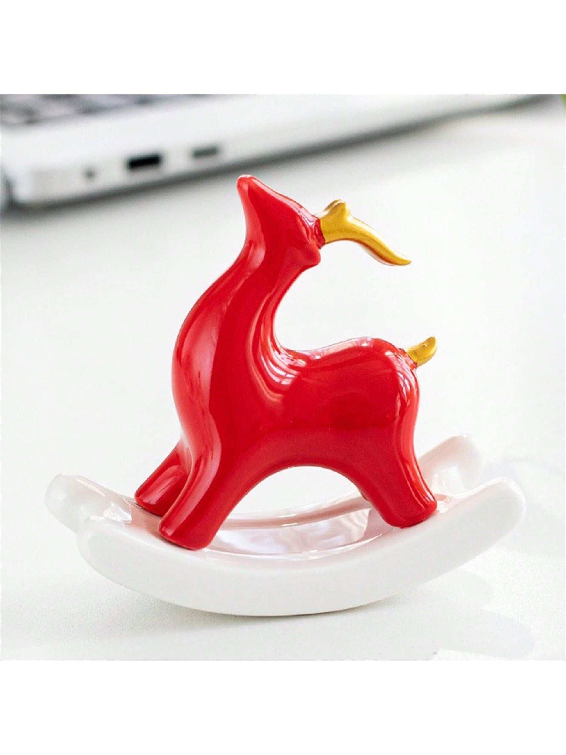 The Charming Ceramic Swing Reindeer is the perfect desk decor for bringing Christmas cheer to your workspace. Made of ceramic, this reindeer adds a touch of charm to any desk or shelf. Its festive swing design captures the holiday spirit and is sure to delight both children and adults alike.