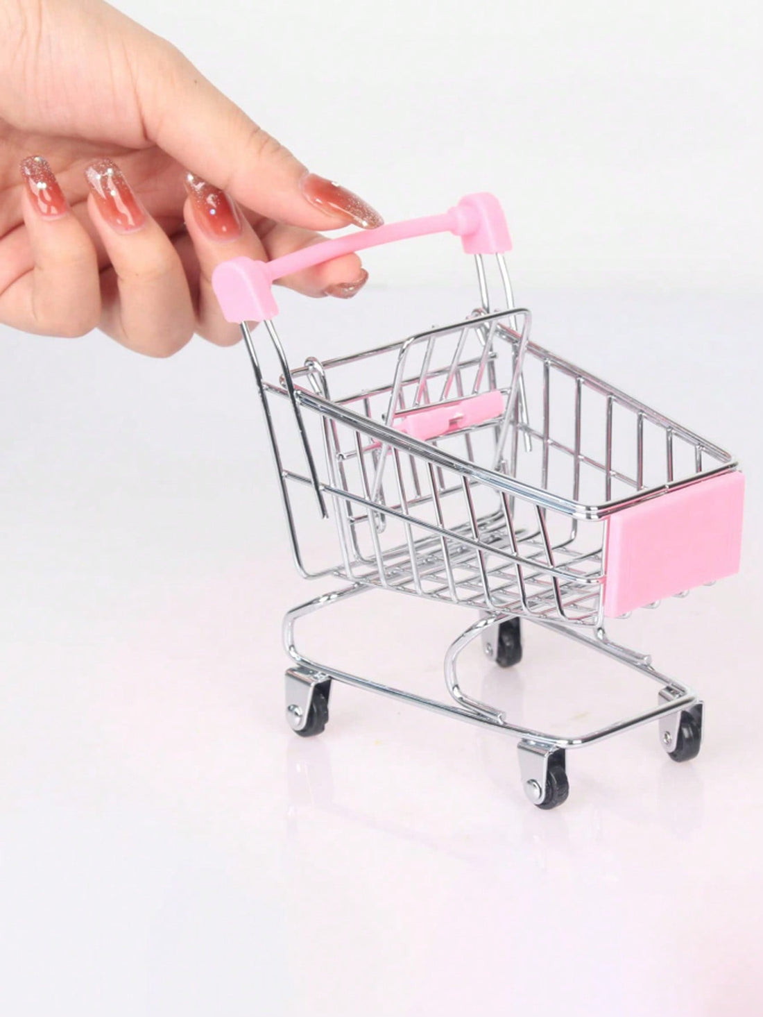 This Charming Mini Supermarket Shopping Trolley Cart is designed for both decorative and practical purposes. With its unique and charming design, it adds a touch of whimsy to any room. It can also be used as additional storage for small items. Made with durable materials, it is both functional and stylish.