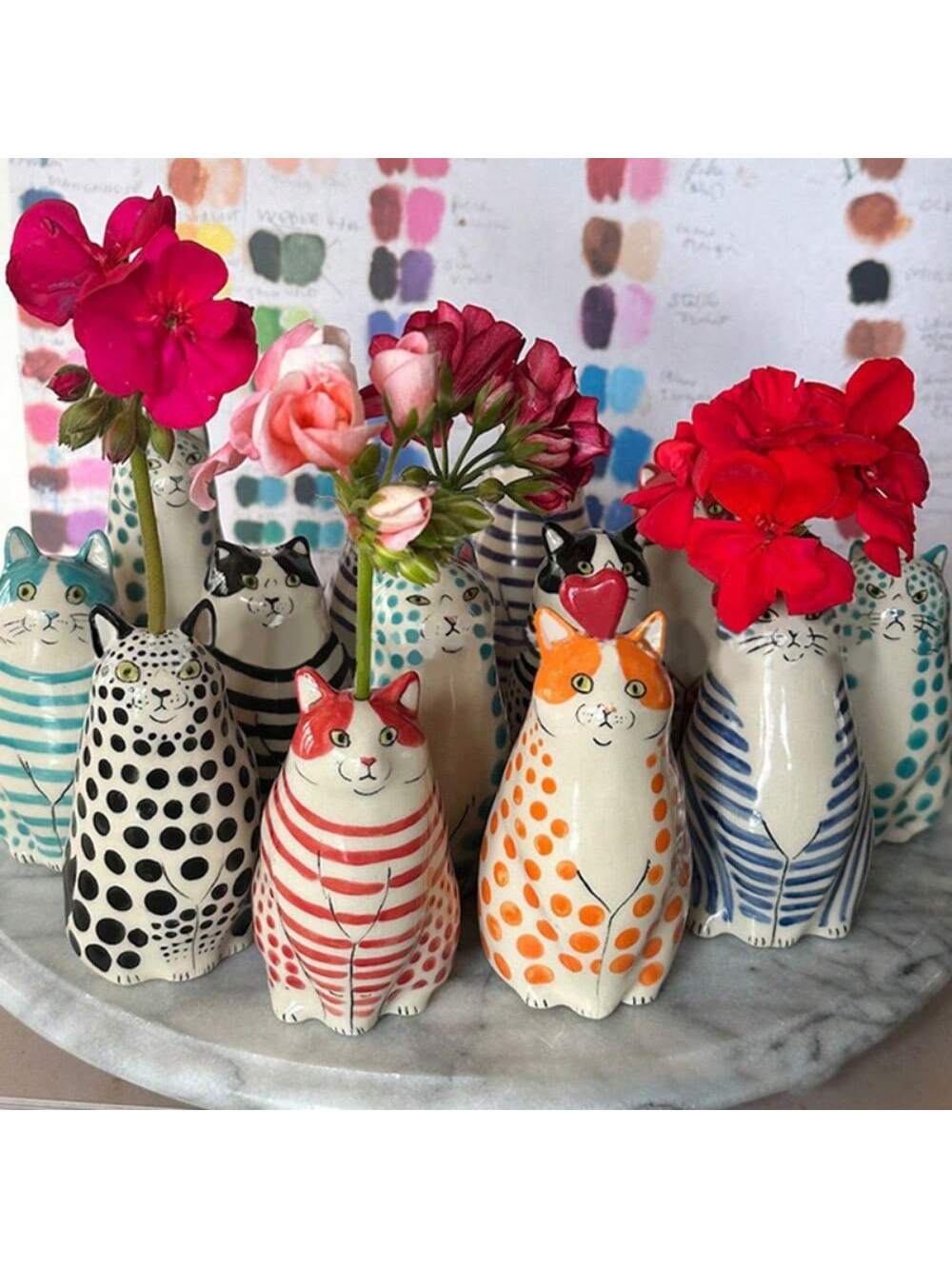 This charming polka dot cat vase is a must-have for any cat lover's home or office. Handcrafted from high-quality resin, this planter adds a touch of whimsy to any space. Show off your love for cats with this unique and functional piece of decor.