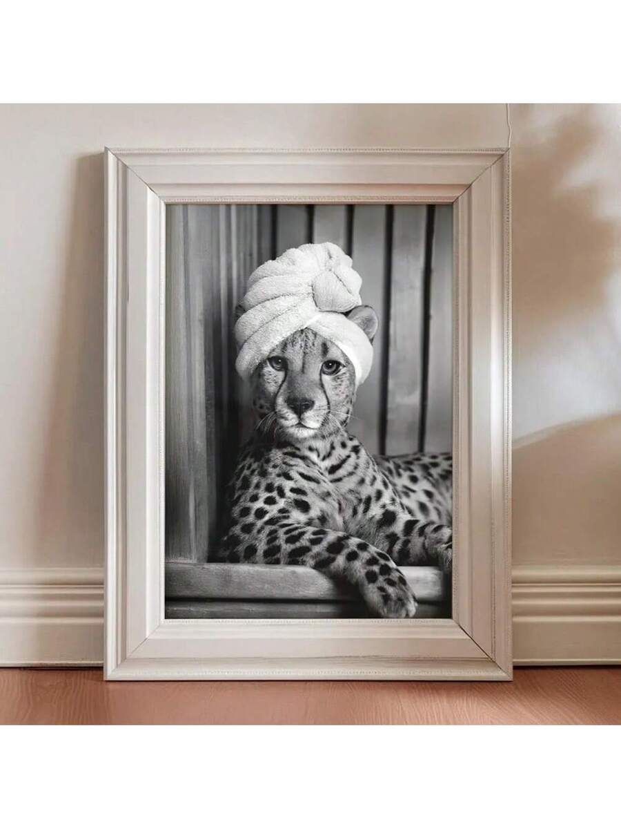 Silver framed black and white cheetah wearing a towel turban on a wood floor