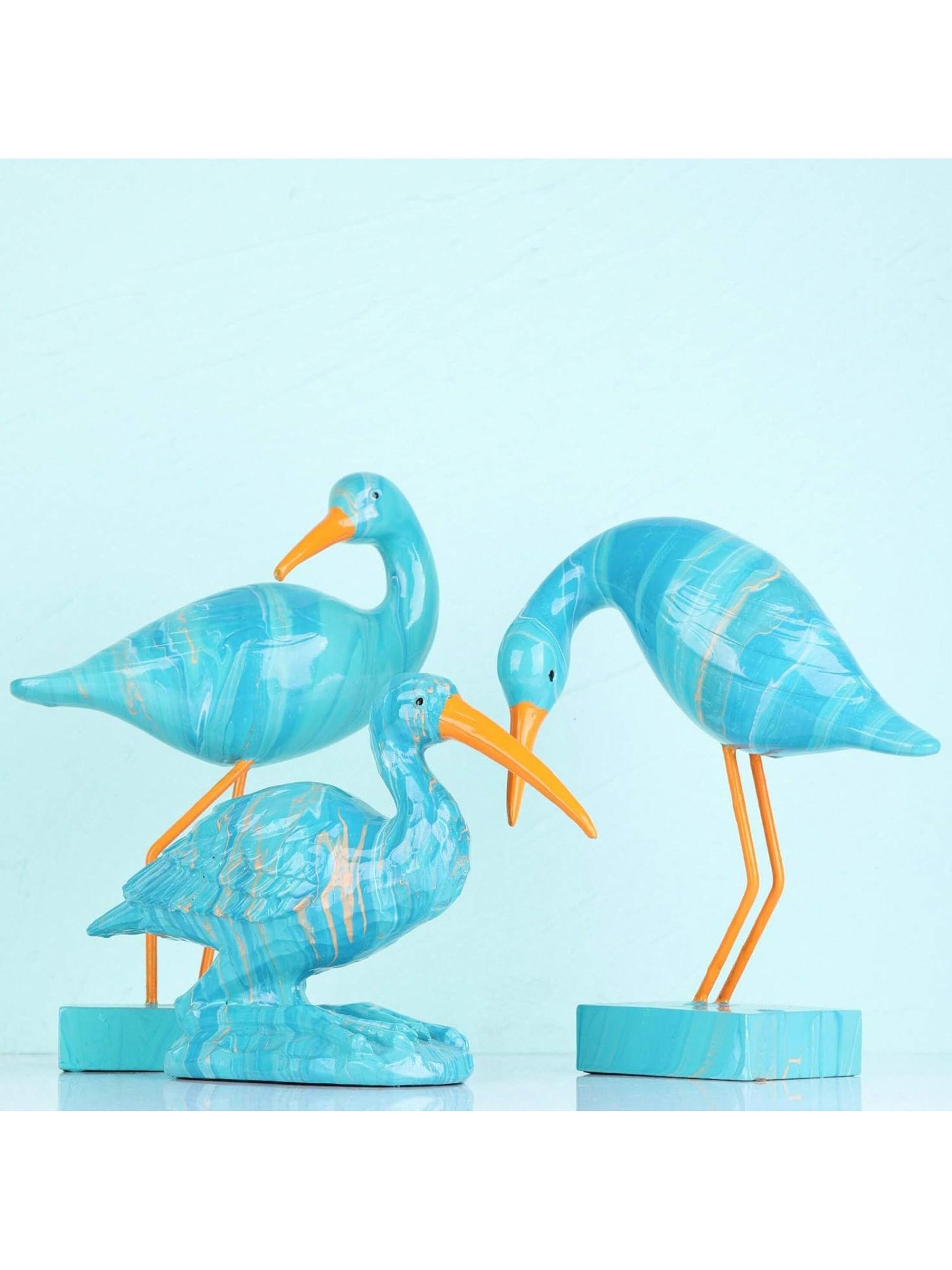 Elevate your living space with our Chic Blue Flamingo Figurine. Crafted from stylish resin, this unique home décor accent adds a touch of sophistication to your office, bookshelf, or desk. Featuring a sleek design and vibrant color, it's the perfect addition to any modern space.