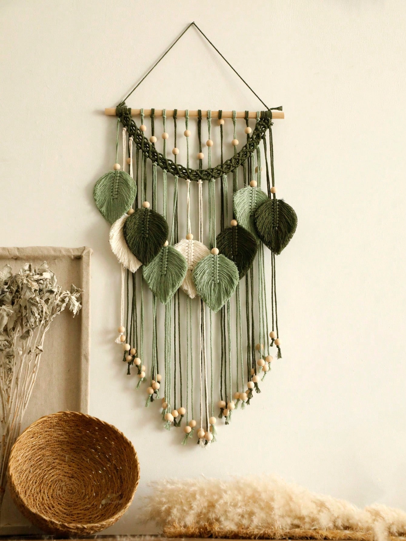 Elevate your living space with our Chic Boho Macrame Leaves Wall Hanging. Handcrafted with intricate weaving techniques, this tapestry adds a stylish touch to any room. Made from high-quality materials, our beautiful decor piece is durable and versatile. Bring nature indoors with the stunning macrame leaf design.