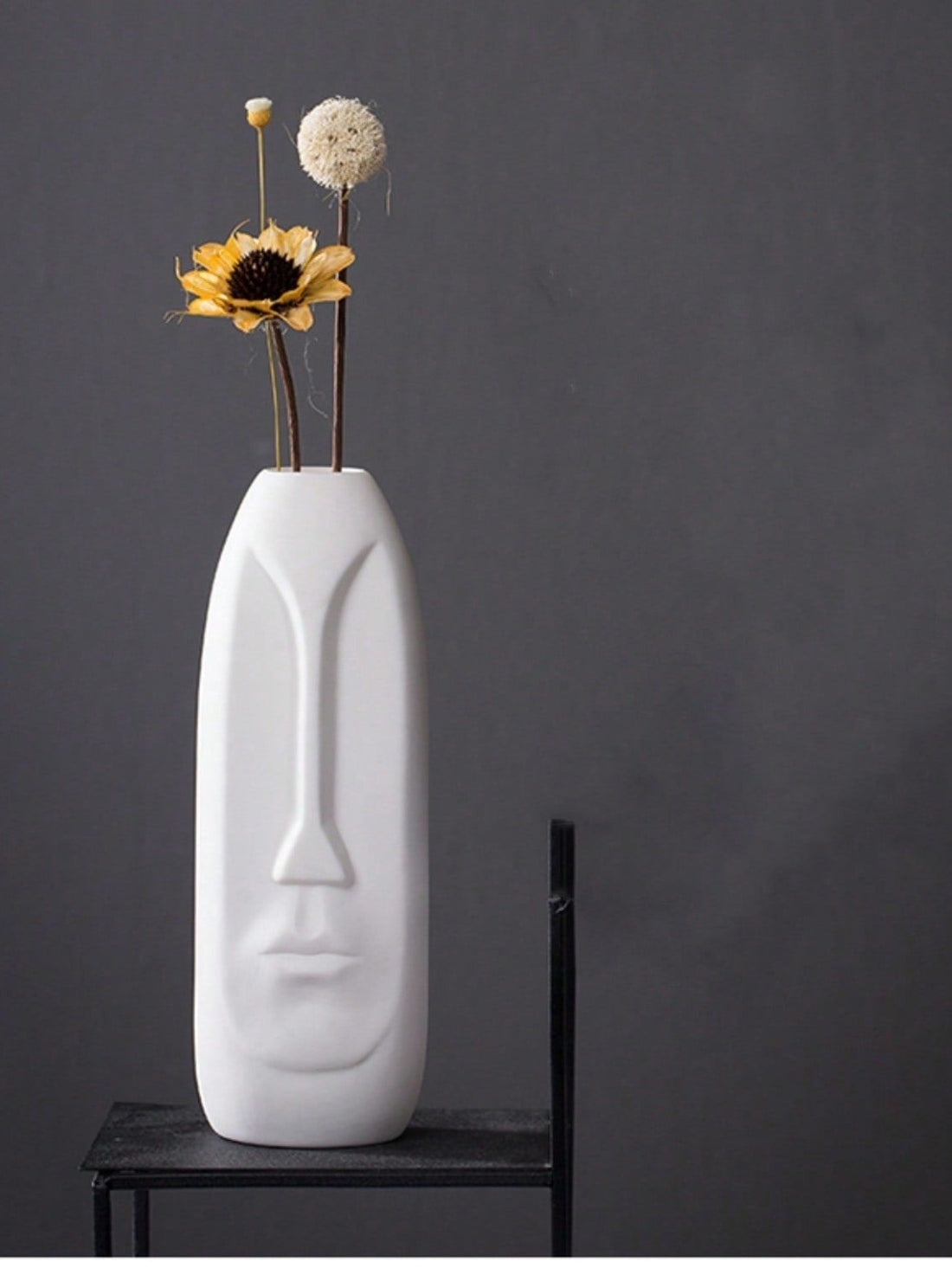 Elevate your home decor with a touch of vintage elegance. This chic European-style ceramic face vase is the perfect holder for dried flowers, adding a cozy and sophisticated feel to any room. Crafted with intricate details, it is a beautiful addition to your decor.