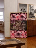 Gold framed pink floral collage with magenta eyed spotted cat in warm room
