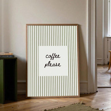 Framed coffee please striped wall print leaning by a doorway and stacked books