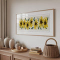 Framed horizontal sunflower wall art above wood console in neutral living room