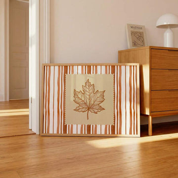 Rust orange maple leaf canvas art in warm wood interior