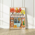 Autumn coffee shop watercolor wall art in a light wood-look frame
