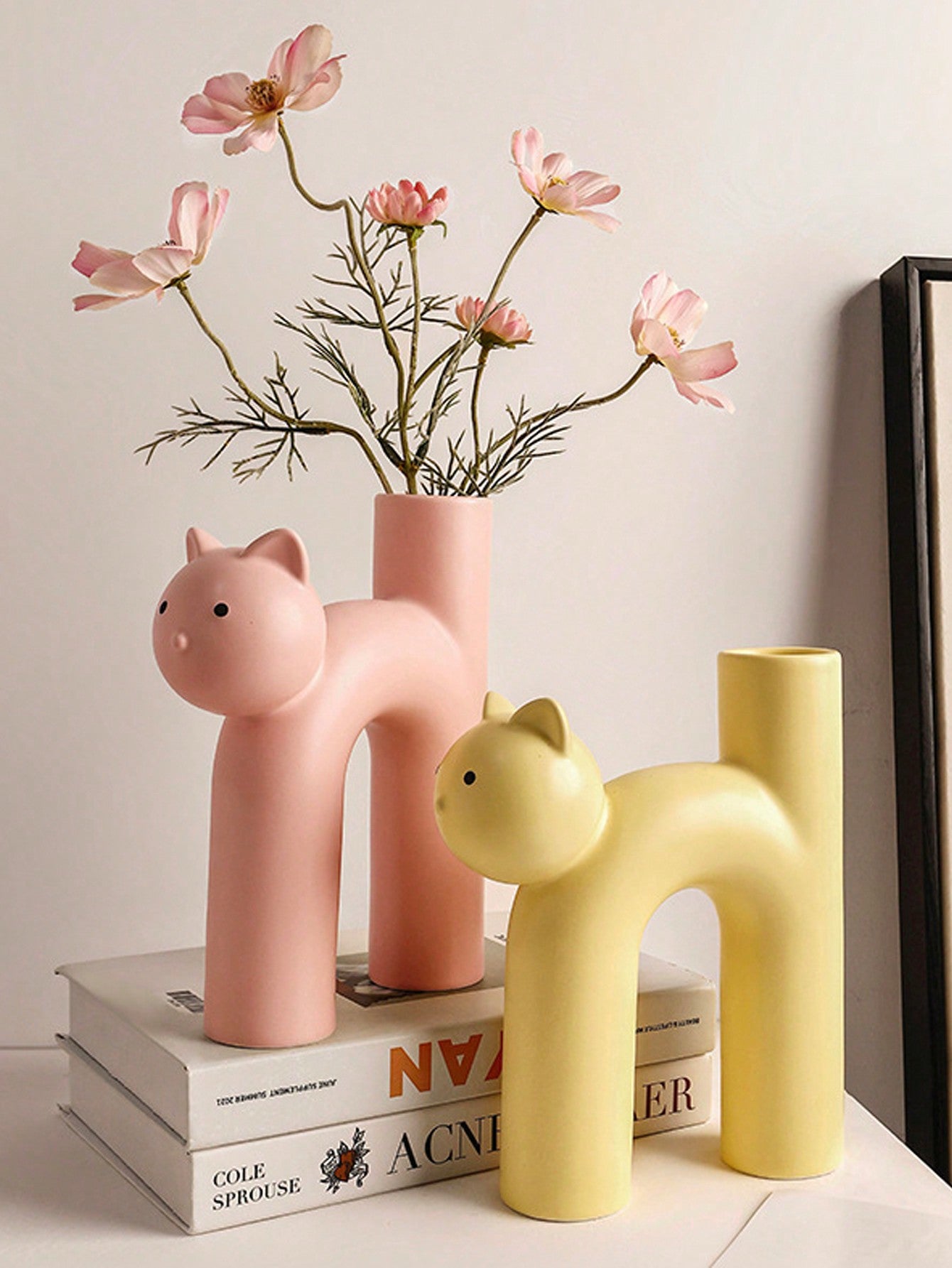 Add a touch of whimsy to your home decor with our Cute Cat Shape Vase. With its simple Scandinavian design, this vase is perfect for displaying your favorite flowers or plants. Made with high-quality materials, it's a charming addition to any room.