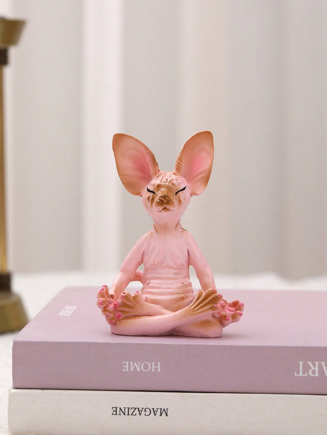 This adorable sculpture is perfect for those looking to add a touch of charm and style to their home decor. Made with high-quality materials, this Sphynx cat sculpture is not only aesthetically pleasing but also durable. Its unique design will surely impress any cat lover and add character to any space.