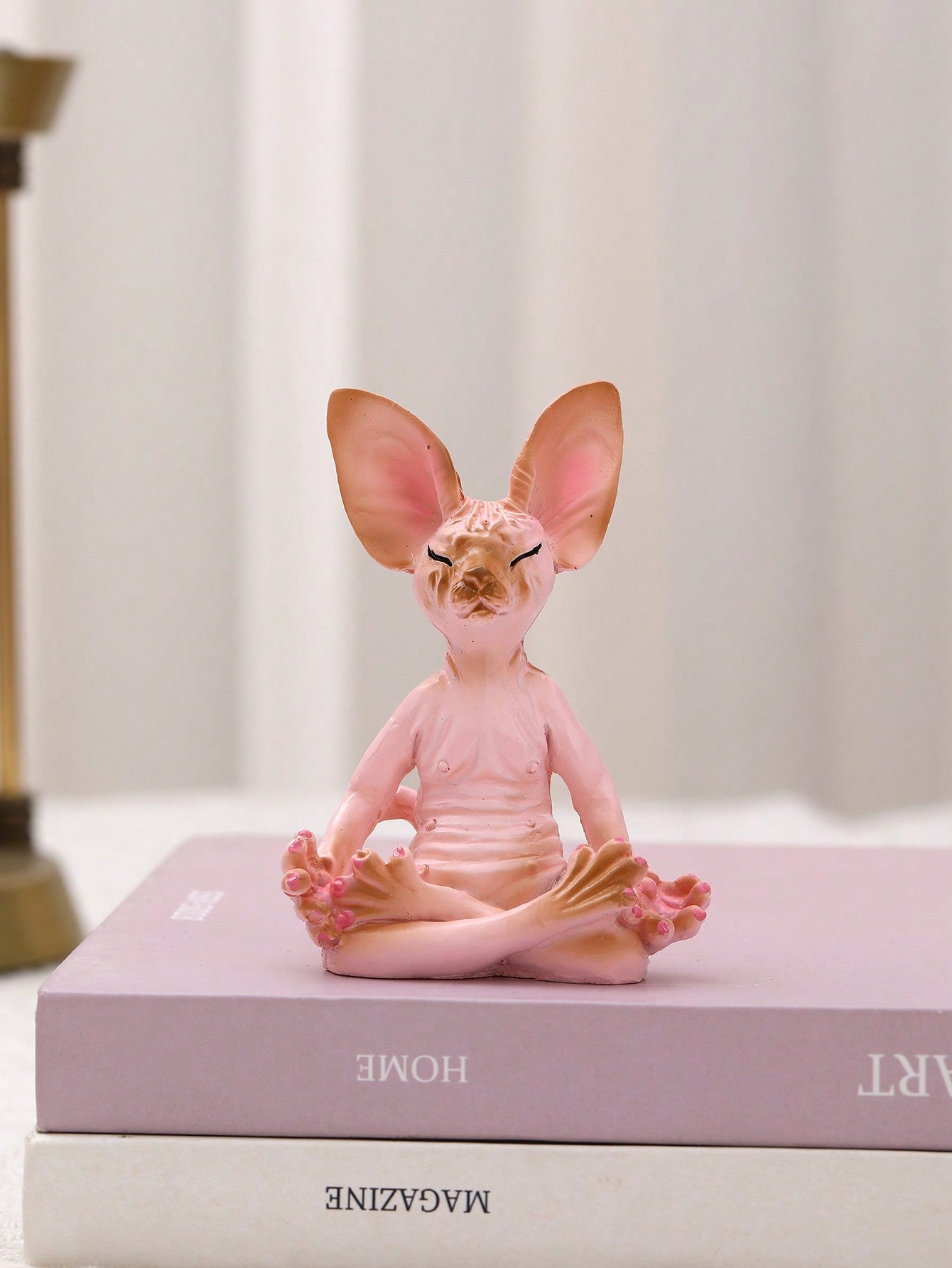 This adorable sculpture is perfect for those looking to add a touch of charm and style to their home decor. Made with high-quality materials, this Sphynx cat sculpture is not only aesthetically pleasing but also durable. Its unique design will surely impress any cat lover and add character to any space.