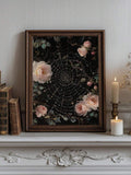 Brown framed pink rose artwork with a jeweled spiderweb above a candlelit mantel