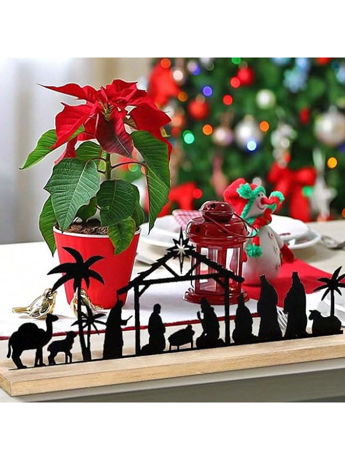 Expertly crafted, this elegant black metal Nativity Scene with wooden base is the perfect addition to your Christmas table decoration. The intricate design and high-quality materials make it a stunning centerpiece that will enhance any holiday display. Celebrate the season with this charming and timeless piece.