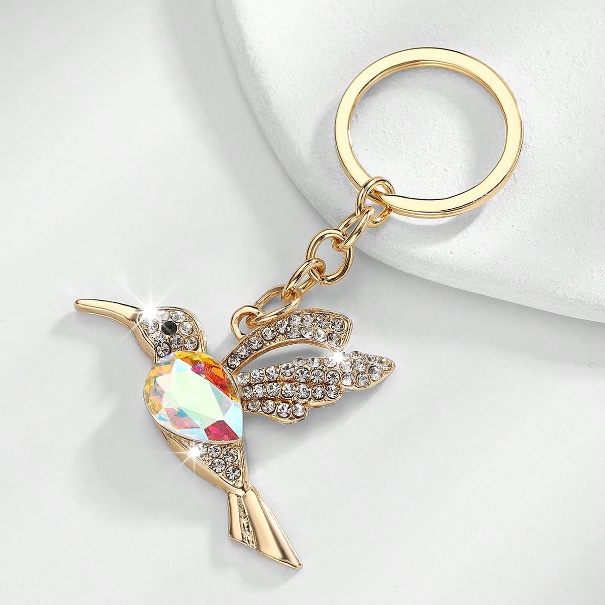 Add a touch of European-American style to your purse with our Elegant Crystal Hummingbird Keychain. Made with high-quality crystals, this keychain is not just a stylish accessory but also a durable and practical one. Elevate your style and stay organized with this elegant keychain.