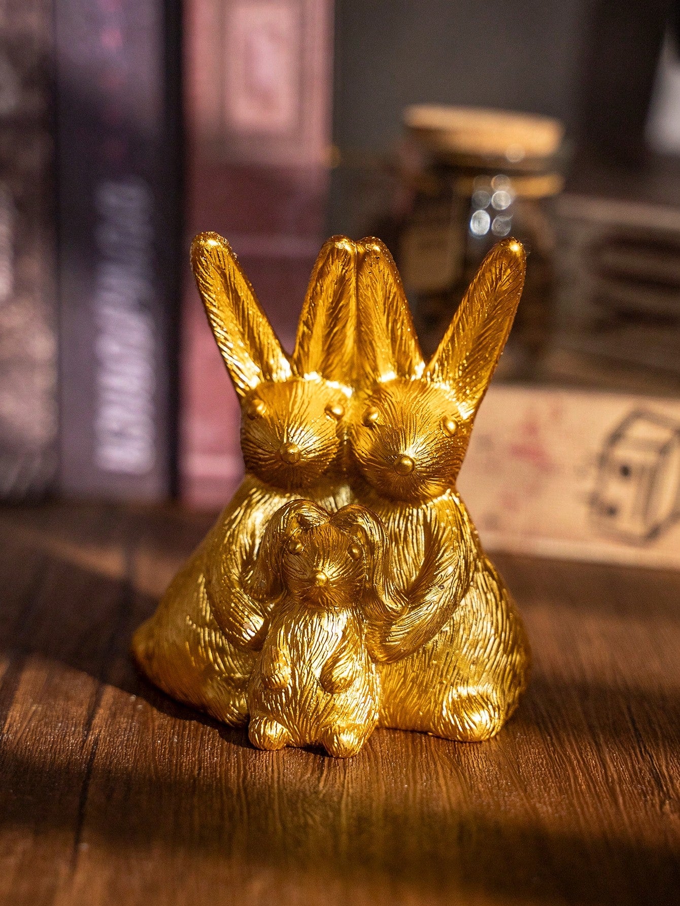 Enhance your home decor with our Elegant Gold Bunny Family Figurine. Perfect for adding a touch of charm to your Easter celebrations and year-round ambiance. Crafted with attention to detail and featuring a luxurious gold finish, this figurine is sure to impress. Add a touch of elegance to any space with this stunning piece.
