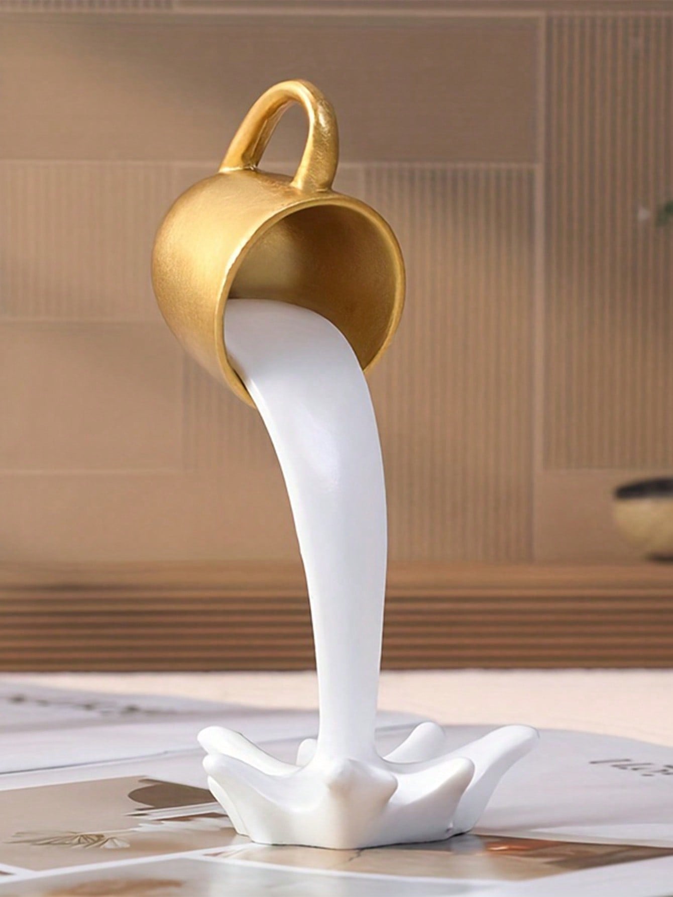 Add a touch of elegance to your home decor with our Elegant Gold Resin Coffee Fountain. This luxurious mug ornament is perfect for coffee lovers and adds a sophisticated touch to any room. Made with high-quality resin, it's not just a decoration, but a statement piece.