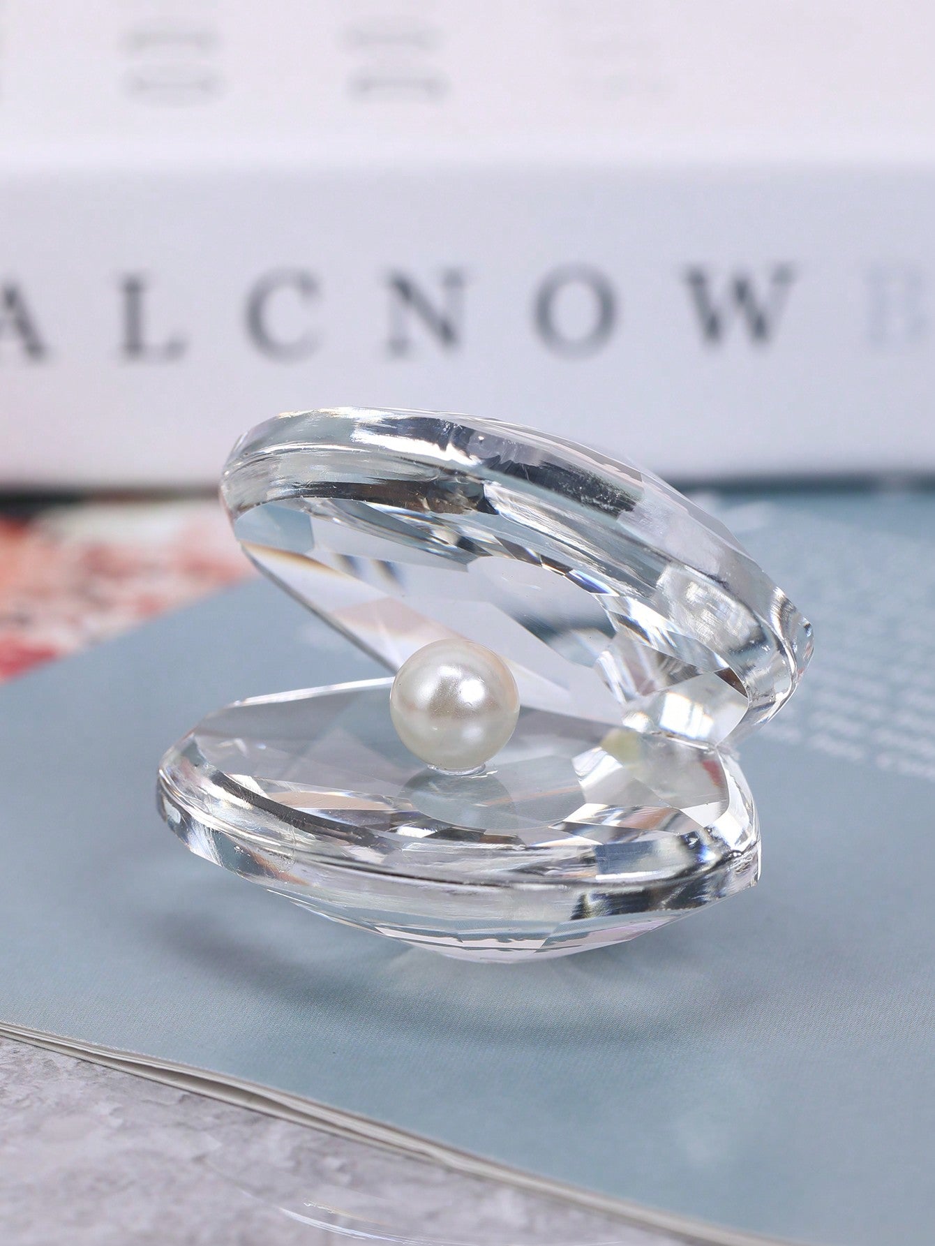 Add a touch of coastal chic charm to your home with our elegant shell-shaped decorative accent. Crafted with exquisite detail, this piece is the perfect addition to any room. Its unique design will bring a touch of the sea to your home, creating a serene and calming atmosphere.