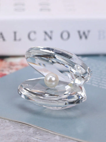 Add a touch of coastal chic charm to your home with our elegant shell-shaped decorative accent. Crafted with exquisite detail, this piece is the perfect addition to any room. Its unique design will bring a touch of the sea to your home, creating a serene and calming atmosphere.