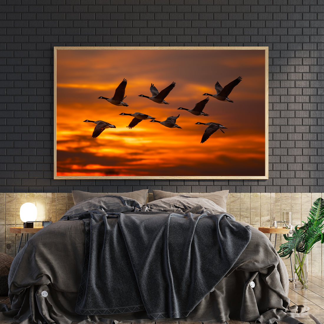 Capture the serene beauty of nature with this striking canvas wall art featuring a flock of geese silhouetted against a vibrant orange sunset sky. This wildlife photography piece brings warmth and movement to any space, making it an ideal focal point for living rooms, bedrooms, or above sofas.