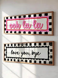 Ooh la la and love you bye checkerboard canvas signs displayed as pair
