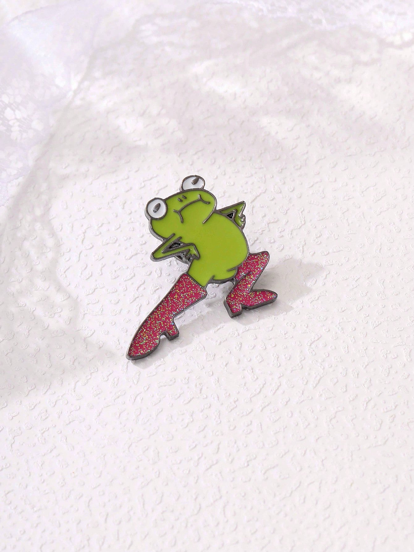 Celebrate your love for fashion and cute critters with Froggy Fashion's Cartoon High Heel Brooch. This delicate and charming accessory showcases a playful frog sitting atop a fashionable high heel shoe. Perfect as a gift for any fashionista or animal lover, this brooch will add a touch of whimsy to any outfit.