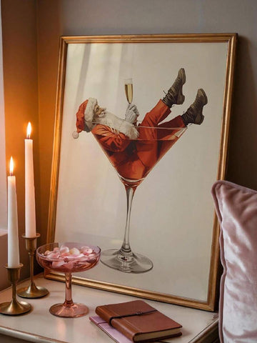 Funny Santa in a red cocktail glass canvas wall art in a gold frame