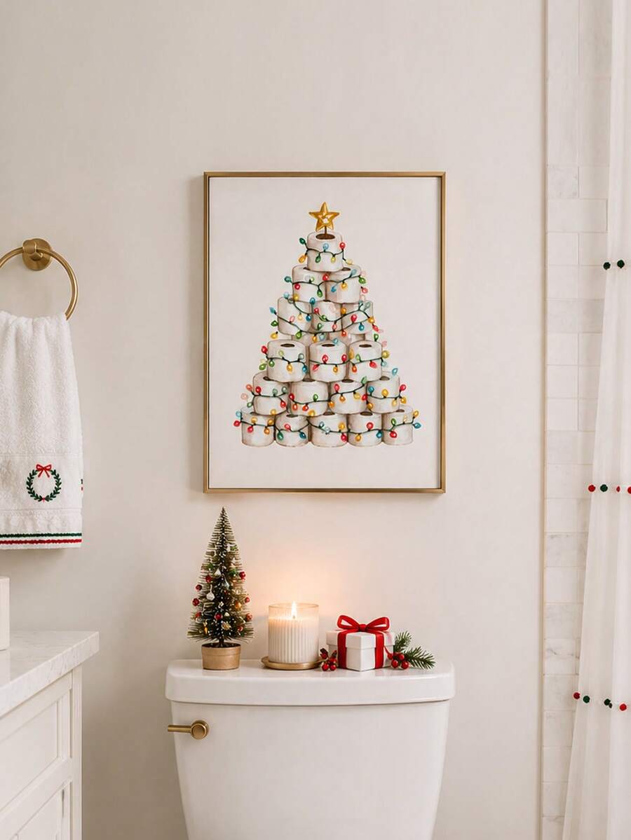 Framed toilet paper Christmas tree print above a bathroom toilet with holiday accents