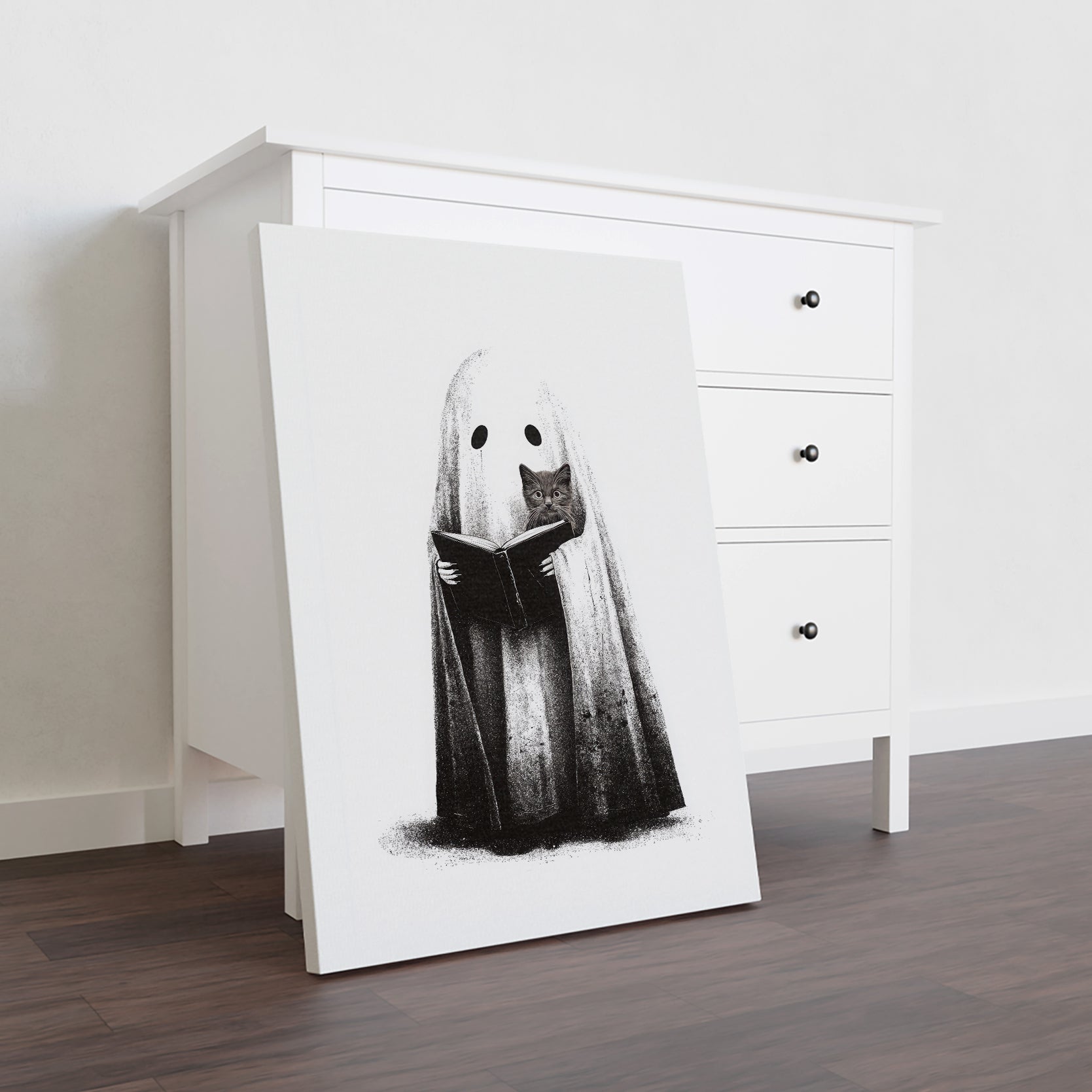 Elevate your home decor with this expert-crafted black and white Halloween canvas print featuring a ghost reading alongside a curious cat. Perfect for living rooms, sofa backdrops, or bedside decoration, this artwork adds a subtle yet sophisticated seasonal touch. Its monochrome palette ensures seamless integration with various interior styles, creating a captivating focal point that blends festive charm with timeless elegance.