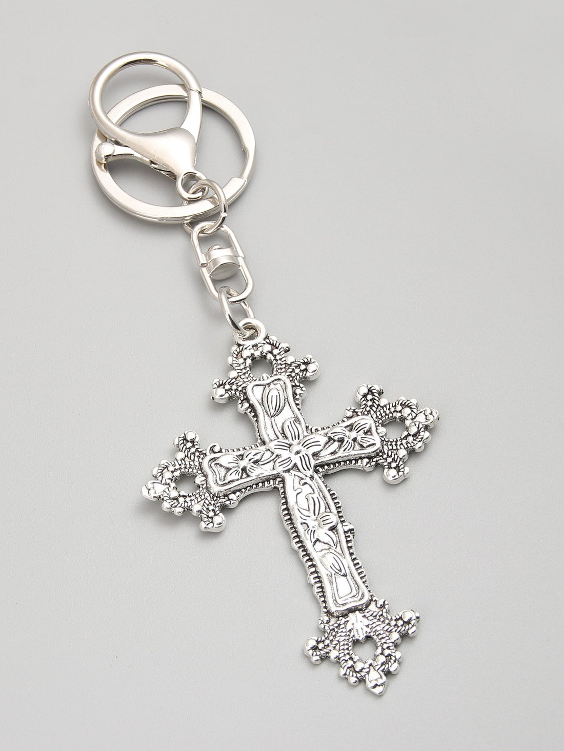 Elevate your accessories game with our glamorous floral cross keychain. Made from high-quality materials, this keychain adds a touch of elegance to any outfit. With its intricate design and durable construction, it's the perfect way to keep your keys organized while making a stylish statement.