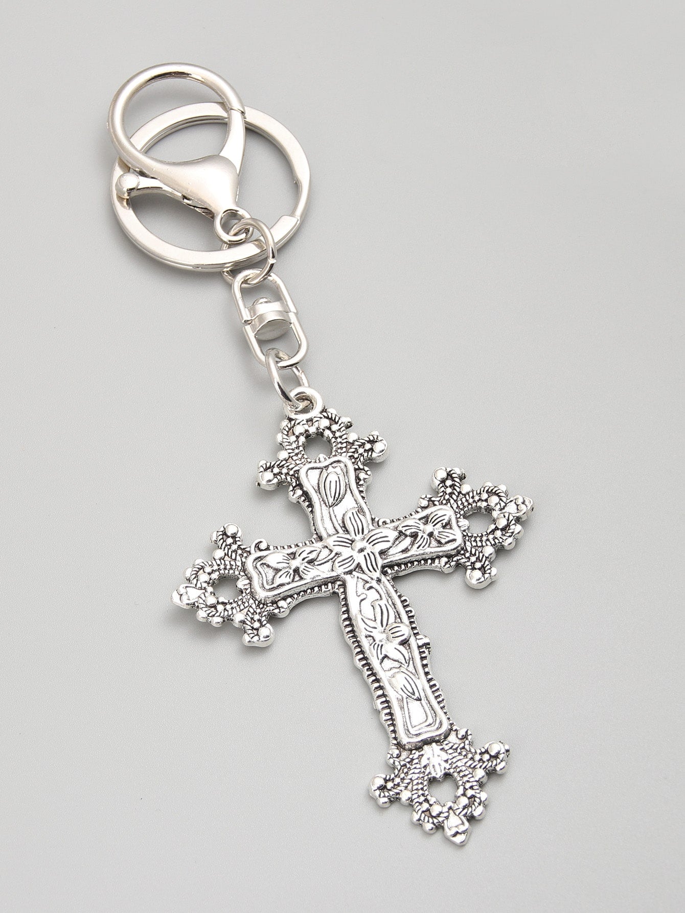 Elevate your accessories game with our glamorous floral cross keychain. Made from high-quality materials, this keychain adds a touch of elegance to any outfit. With its intricate design and durable construction, it's the perfect way to keep your keys organized while making a stylish statement.